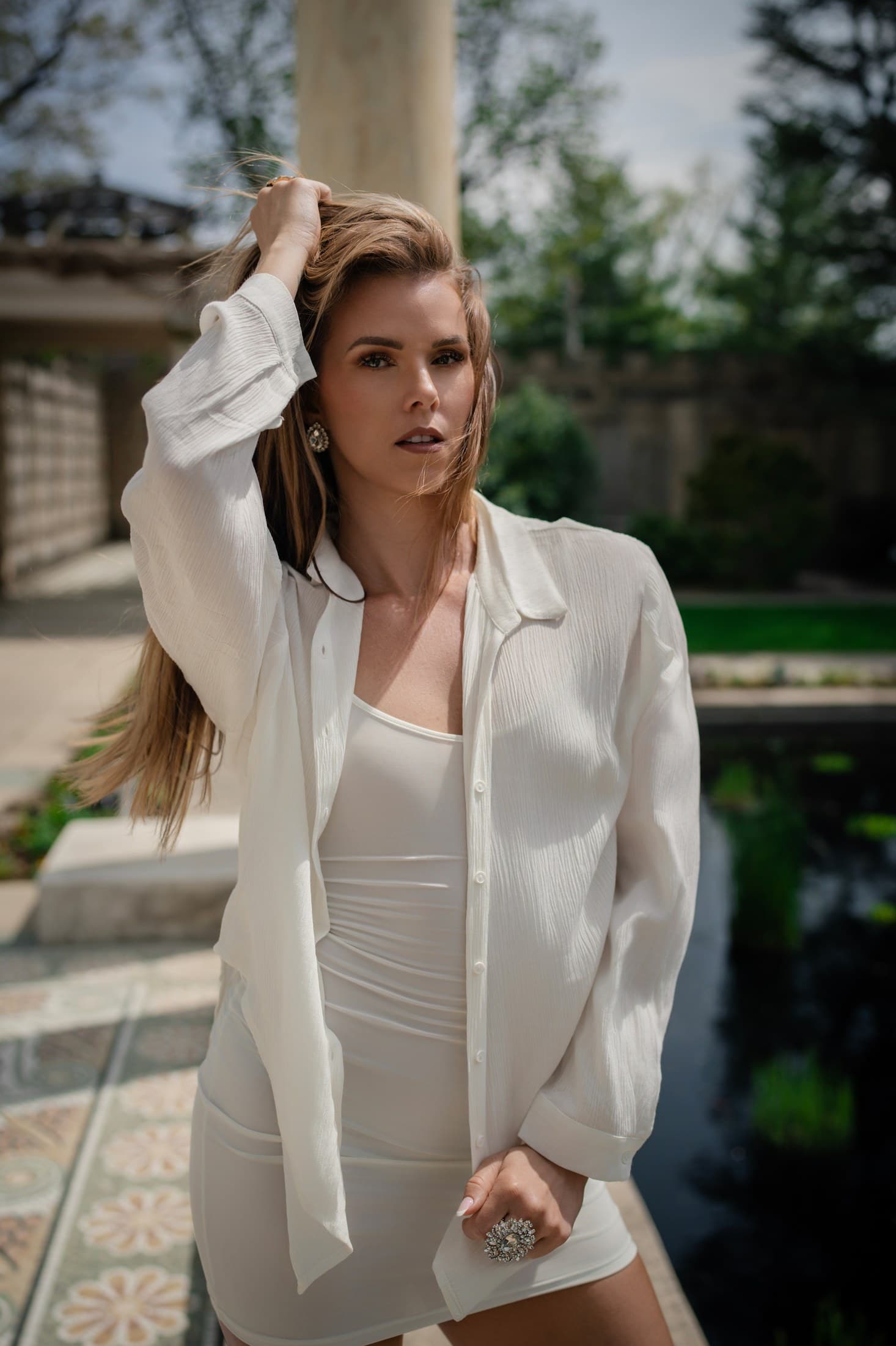 Molly Hagman with hand in hair by the garden pond — Spring shoot by Alexis Pesante 2025