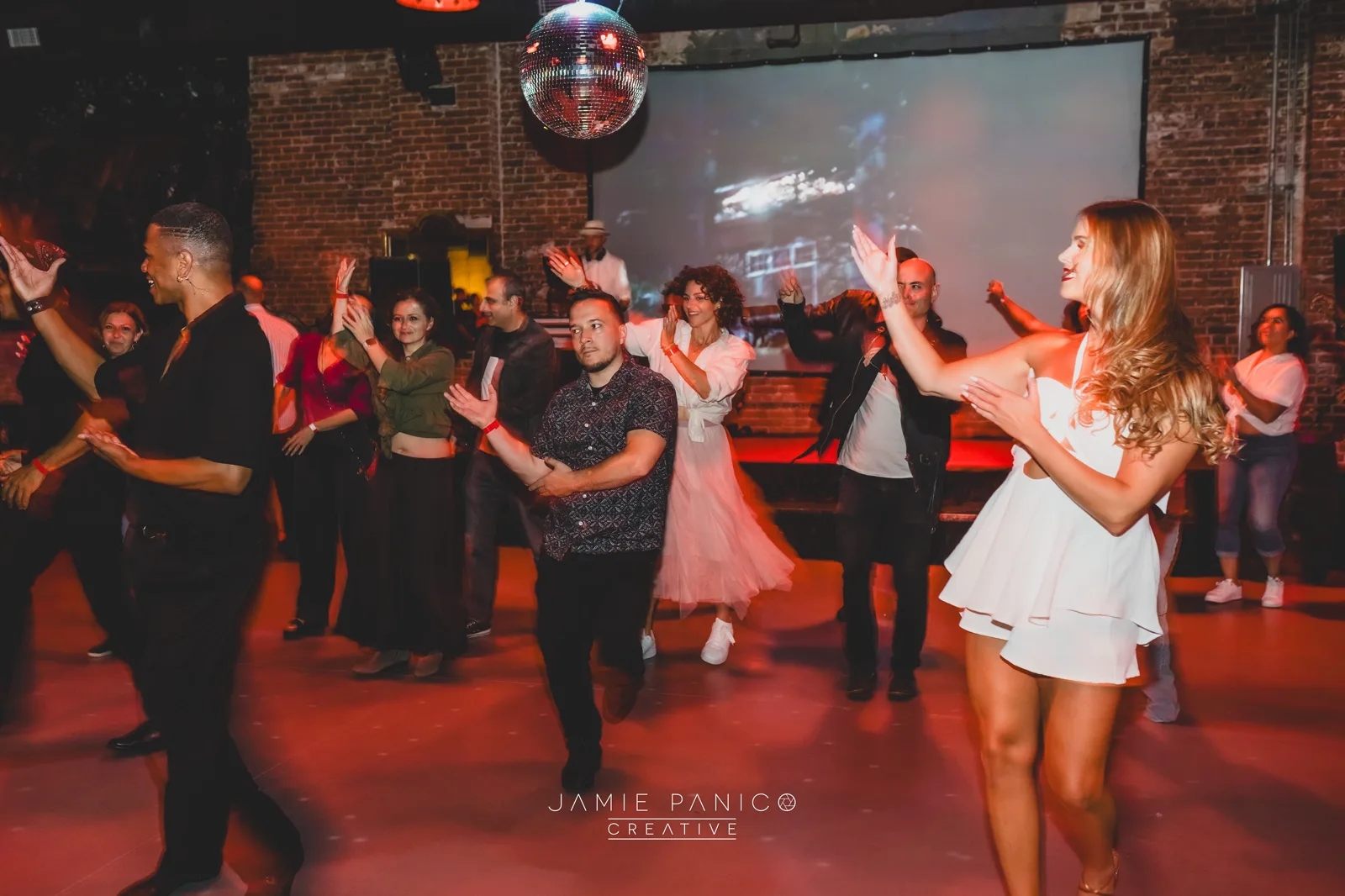 Molly Hagman leading a corporate team through an interactive Latin dance session