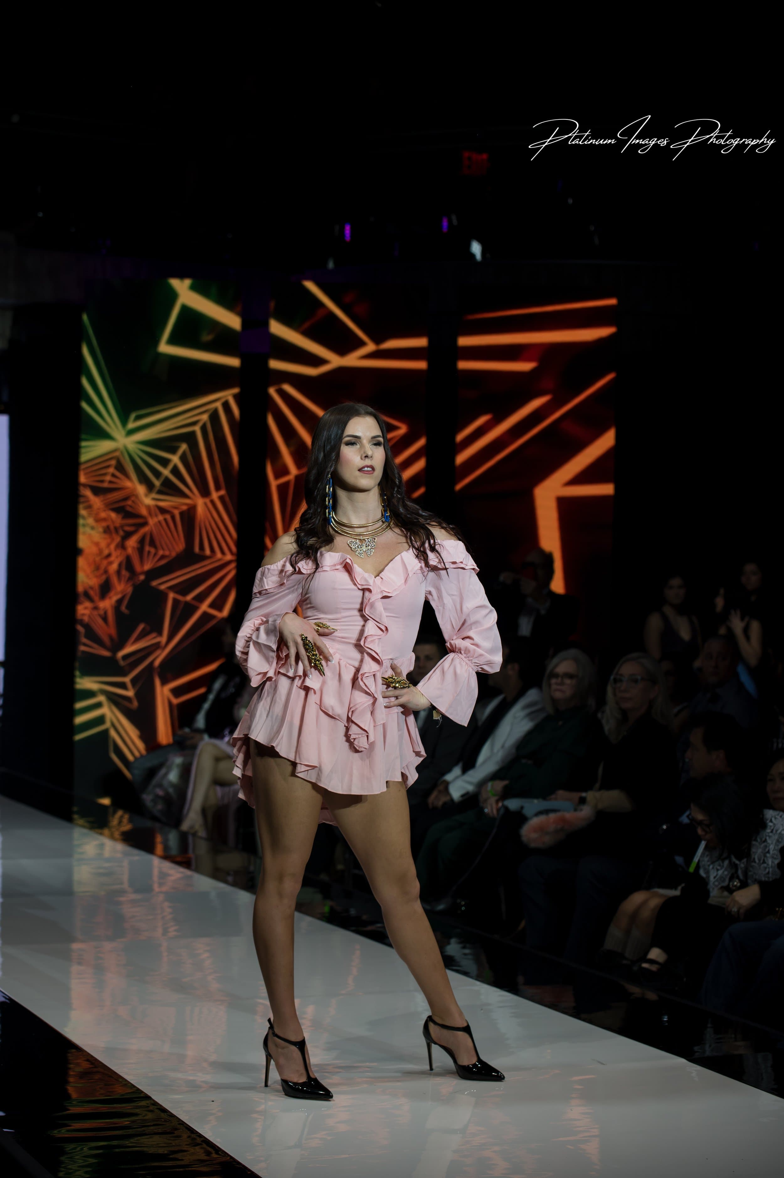 Molly Hagman on the runway in a pink ruffled dress at NYFW