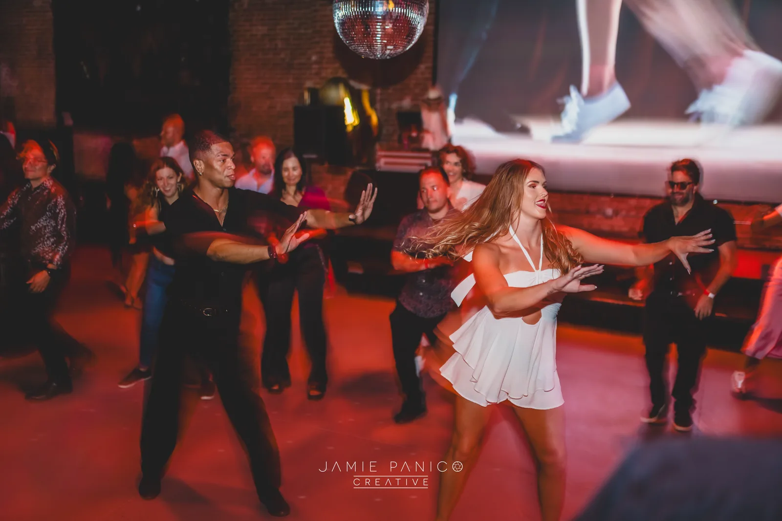 Molly Hagman leading office workers through a corporate Latin dance workshop